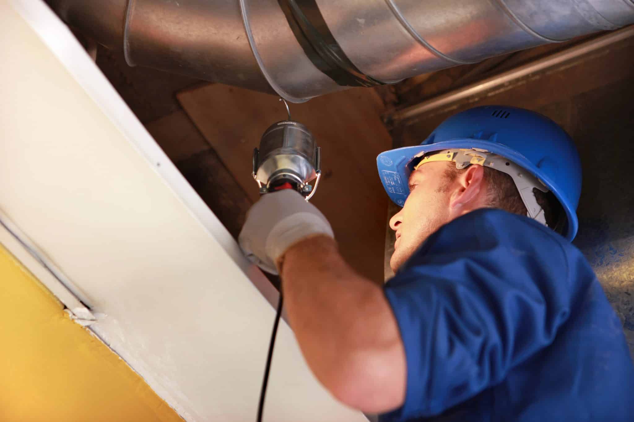 HVAC technician servicing a residential air conditioning unit